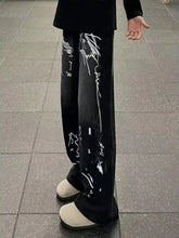 Men’s black wide leg jeans with bold white graffiti print wide markings along the sides in plus size