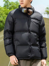 Men’s full size lightweight packable zip up black puffer jacket with quilted design and elastic cuffs