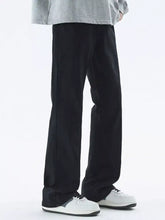Black men’s full size loose fit jeans with wide-leg relaxed silhouette and subtle vertical seam detailing
