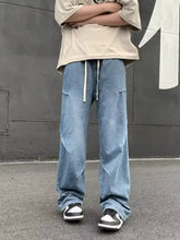 Men’s full size light-wash denim loose fit jeans with relaxed wide-leg cut and visible stitching details
