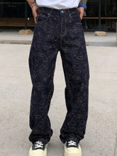 Men’s dark blue denim loose fit jeans featuring intricate white line-art floral and swirling patterns in plus size