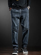 Men’s full size loose fit jeans in dark blue denim with subtle distressed details and a relaxed loose fit design