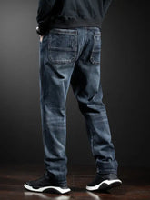 Men’s full size loose fit dark-wash denim jeans with straight-leg cut, subtle fading, and classic back pockets
