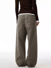 Men’s full size loose fit jeans in olive green cotton with wide legs and back pocket metal button detail