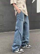 Men’s full size loose fit jeans in light-wash blue denim with a relaxed wide-leg cut and visible stitching details