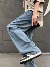 Men’s light-wash denim loose fit jeans with relaxed wide-leg cut and visible stitching details plus size fit jeans