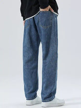 Men’s blue denim loose-fit straight-leg jeans with relaxed cut and visible stitching details in plus size full fit