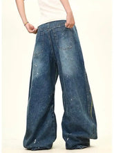 Men’s full size love washed wide leg jeans in medium-wash denim with white paint splatter and yellow zipper detail
