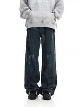 Men’s dark blue denim paint splattered wide-leg jeans with a painterly splatter design plus size fit