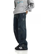 Men’s full size dark-wash denim paint splattered wide leg jeans with loose fit and splattered wide leg stains