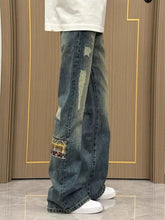 Men’s distressed blue denim wide-leg jeans with faded wash and patchwork detailing perfect for everyday wear