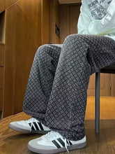 Men’s plus size wide-leg jeans with a gray and white speckled texture paired with classic adidas sneakers