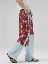 Men’s light blue denim patchwork wide leg jeans with red and beige plaid patchwork shirt tied around the waist