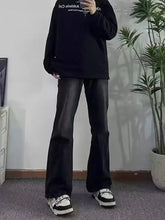 Mens black full size pocketed flare jeans with smooth glossy finish and subtle creases for a stylish look