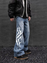 Men’s full size printed wide-leg jeans in blue denim fabric blend with bold white flame design on outer leg