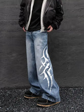 Men’s full size printed wide leg jeans in blue denim fabric blend with bold white tribal-style flame graphic