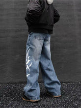 Men’s full size printed wide leg jeans in blue denim fabric blend with white flame design on left leg wide-leg jeans