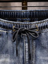 Men’s full size relaxed fit drawstring jeans in dark blue denim with contrasting yellow stitching and drawstring waistband