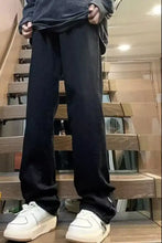 Men’s black relaxed fit jeans in full size with a straight leg cut and subtle side ankle zippers in denim material