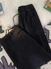 Men’s black relaxed fit jeans with drawstring waist and subtle pleats for comfortable full size fit jeans