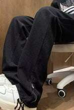 Men’s full size relaxed fit jeans in black tapered jogger style with zipper detail at the cuff for a fit jeans look