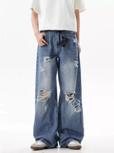 Men’s full size blue distressed ripped wide leg denim jeans with frayed holes and black belt loop detail