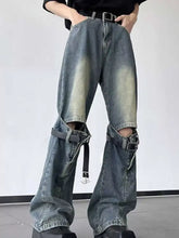 Men’s full size dark-wash ripped wide-leg jeans featuring distressed knees and black belt straps wrapped around the legs