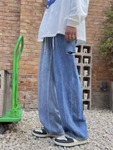 Men’s light-wash blue denim wide leg jeans with distressed ripped knee detail plus size leg jeans