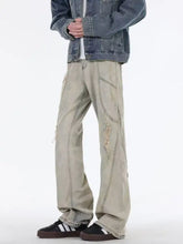 Beige distressed denim men’s full size ripped wide leg jeans with visible stitching and patchwork details