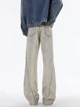 Men’s beige ripped wide leg jeans in full size with contrasting dark stitching and a relaxed tapered fit