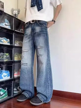Men’s full size ripped wide-leg jeans in blue distressed denim with visible wear patterns and a wide-leg cut