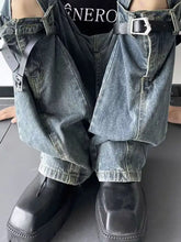 Men’s dark-wash denim wide-leg jeans feature ripped design with black leather straps and silver-toned buckles