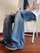 Men’s full size ripped wide-leg jeans in distressed blue denim with ripped knees and a flared leg cut