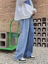 Men’s full size ripped light-wash blue denim wide leg jeans with a relaxed fit and drawstring waistband