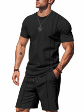 Men’s full size black short sleeve top with subtle vertical ribbed texture and small embroidered chest logo