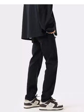 Men’s full size slim fit black tapered trousers with sleek modern cut and subtle stitching details slim fit jeans