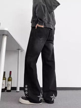 Men’s black denim flare jeans with white star embroidery along outer sides plus size design