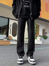 Men’s full size black straight leg denim jeans with slim fit and visible stitching details for plus size wear
