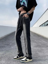 Men’s full size black denim straight leg jeans with a faded gray vertical stripe down the side