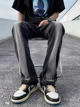 Men’s full size straight leg jeans in black and gray distressed denim with a faded two tone design
