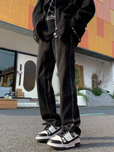 Men’s full size black denim straight leg jeans with white stitching and slightly faded texture