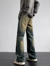 Men’s full size vintage wash loose fit jeans in distressed dark-wash denim with faded green and brown tones