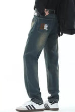 Men’s full size vintage wash dark-wash denim jeans with faded distressed look and embroidered lion patch on back pocket
