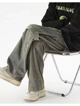 Men’s wide leg cargo jeans in gray green with vintage wash and distressed finish featuring multiple pockets