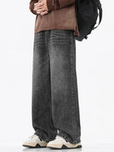 Men’s dark gray wide-leg denim jeans with faded vintage wash and frayed hems in full size vintage wash wide fit