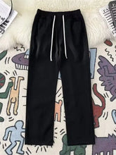 Men’s full size vintage wash wide leg jeans in black with white drawstring cord accents and vintage wash detailing