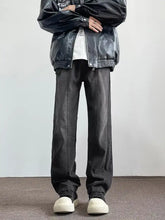 Black leather bomber jacket with silver zippers and button closures paired with vintage wash wide leg jeans