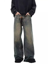 Men’s full size vintage wash wide-leg jeans in faded distressed dark denim with frayed hems and visible fading