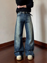 Men’s full size vintage wash wide-leg denim jeans in faded blue with white paint splatter details and plus size fit