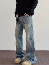 Men’s full size vintage wash wide leg jeans in washed blue denim with a relaxed straight-leg cut and subtle fading